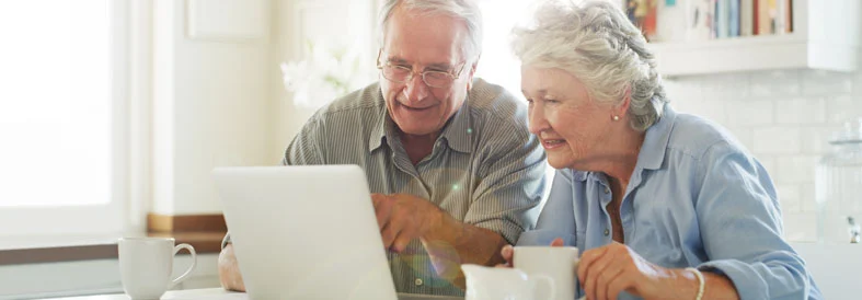 Senior woman confidently using laptop
